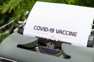 typewriter, paper, covid-19 vaccine